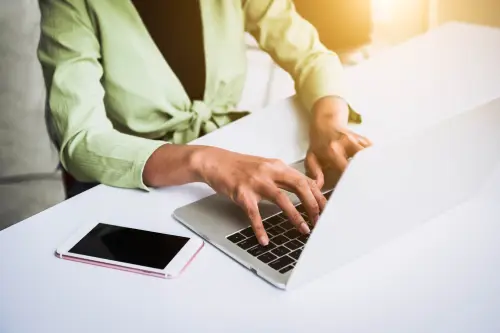 a copywriter writing on her laptop.