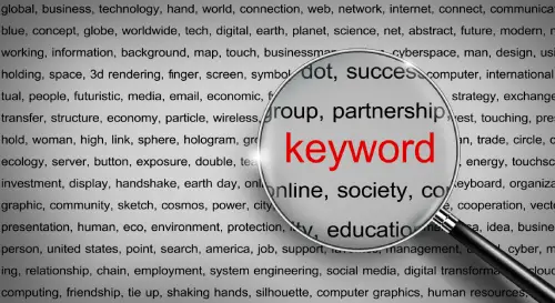 a magnifying glass hovering over the word "keyword" in red, surrounded by other words in black.